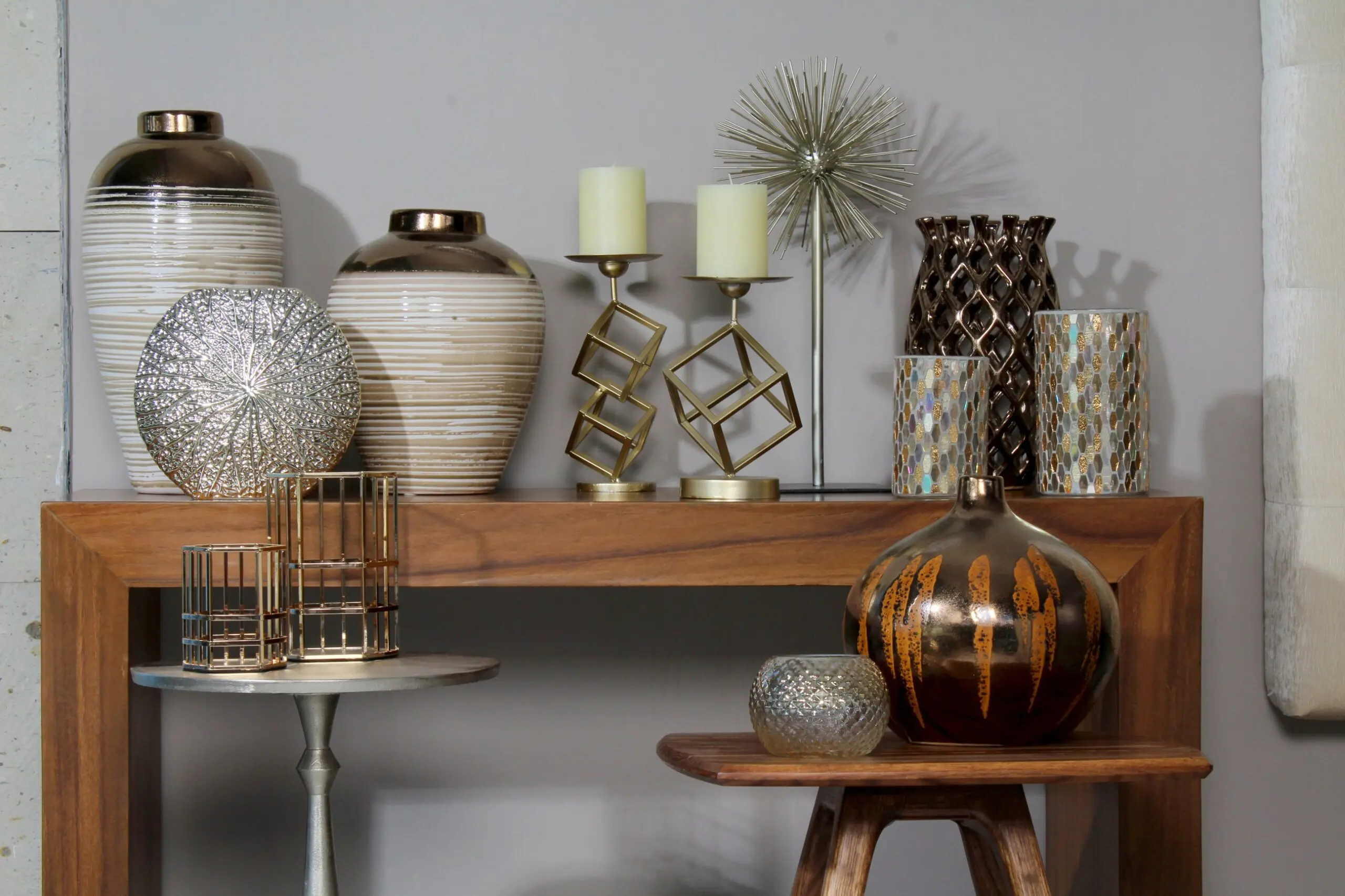 Decorative vases and candles on wooden tables.