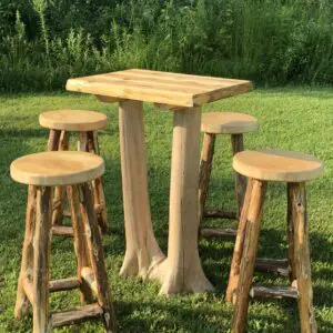 Rustic wooden outdoor table with four matching stools on grass.