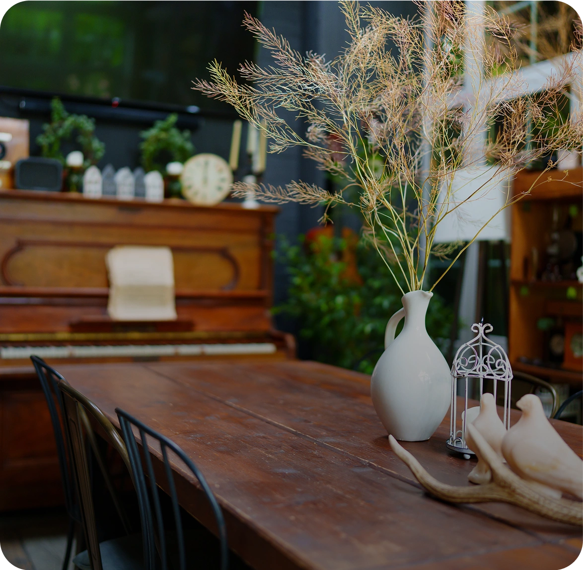 Rustic dining table with vase and decor.