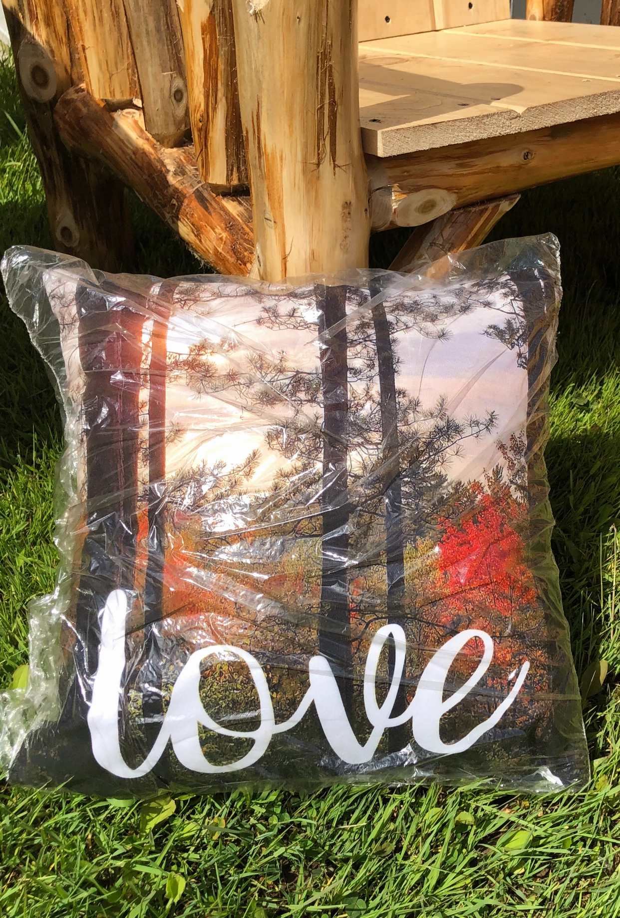 Decorative pillow with a love-themed forest sunset design.