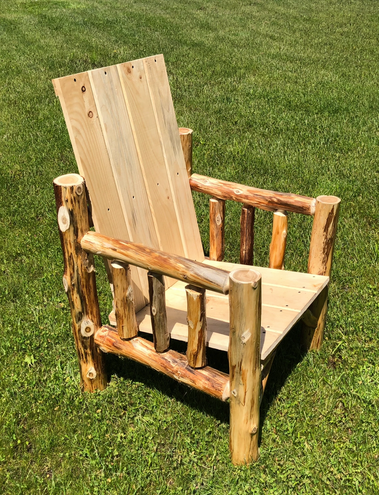 Rustic wooden chair crafted from logs with a natural finish.
