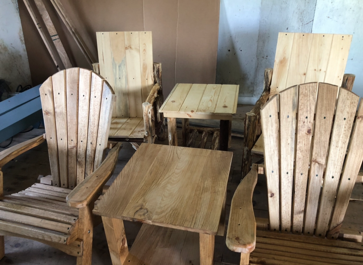 Rustic wooden chairs and tables arranged indoors.