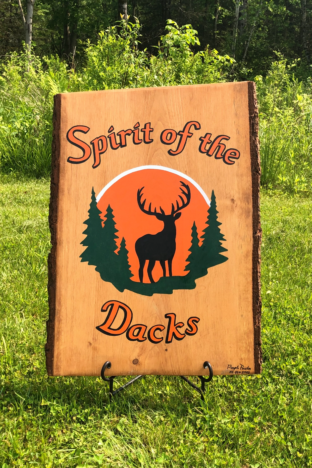 Wooden plaque with deer and trees, reading 'Spirit of the Docks'.