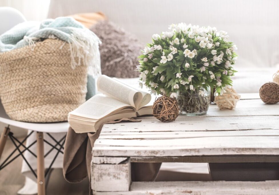 Cozy living room with flowers and books.